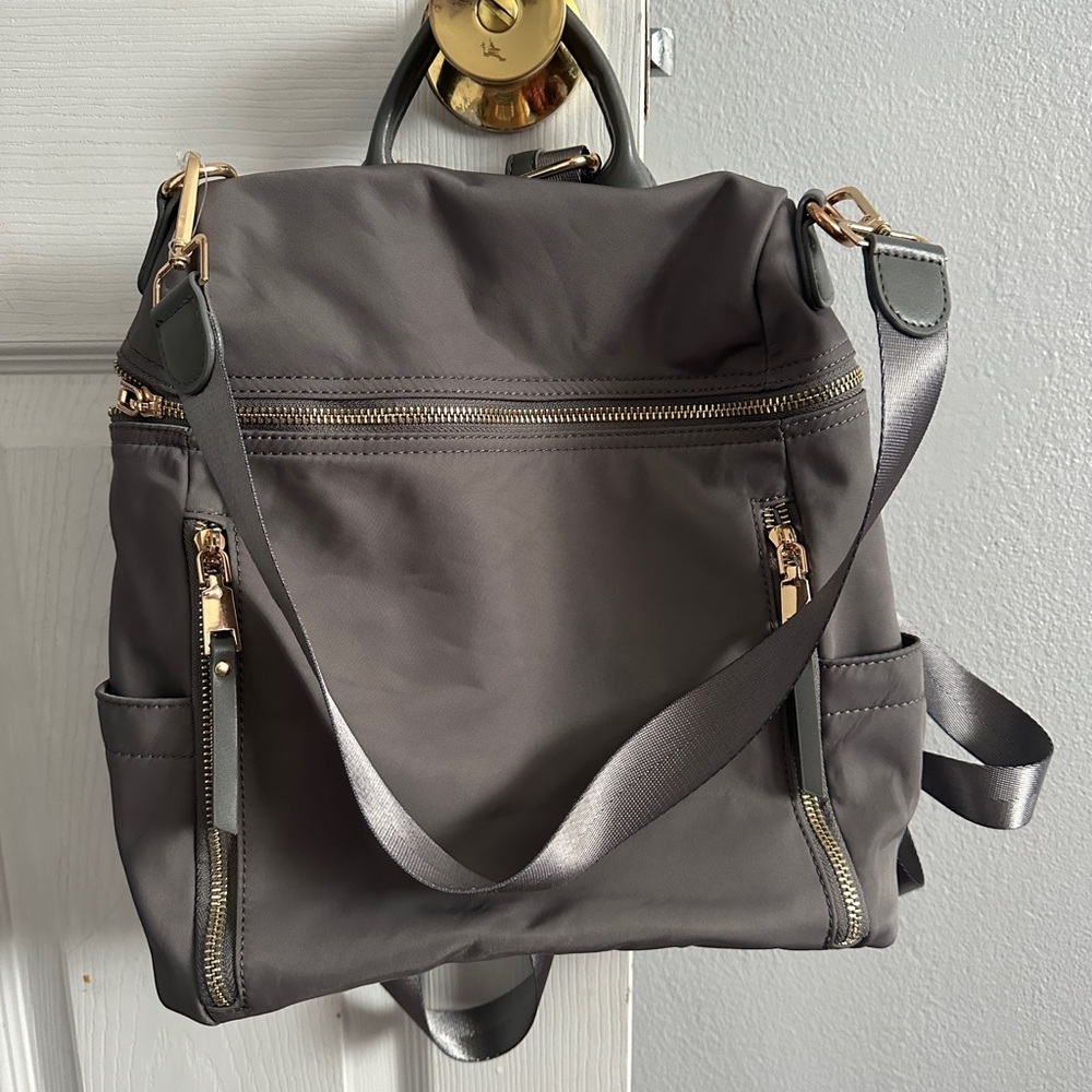 Like new and clean used 3 times. Can use it as a backpack and purse.